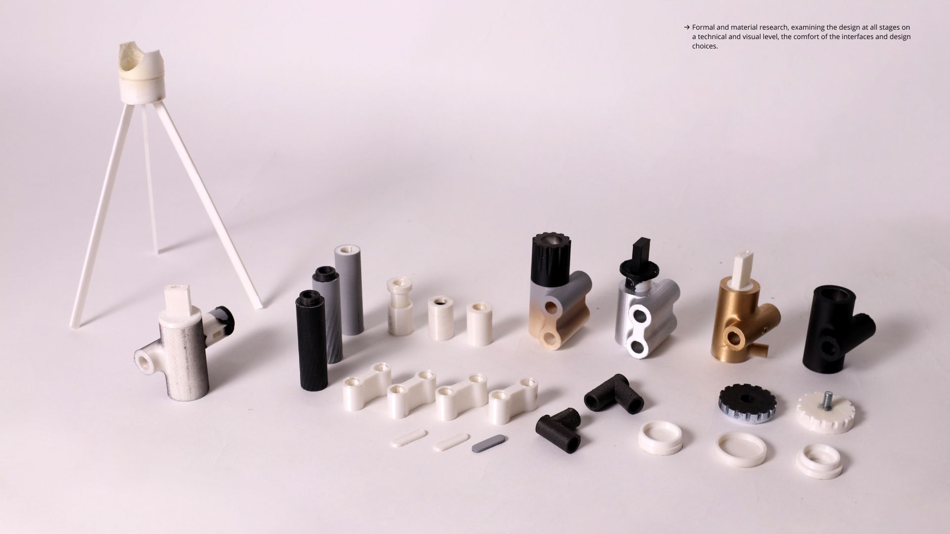 Flat-lay of Rodlight components — machined joints and the wireframe stand in metal, plastic and brass finishes.
