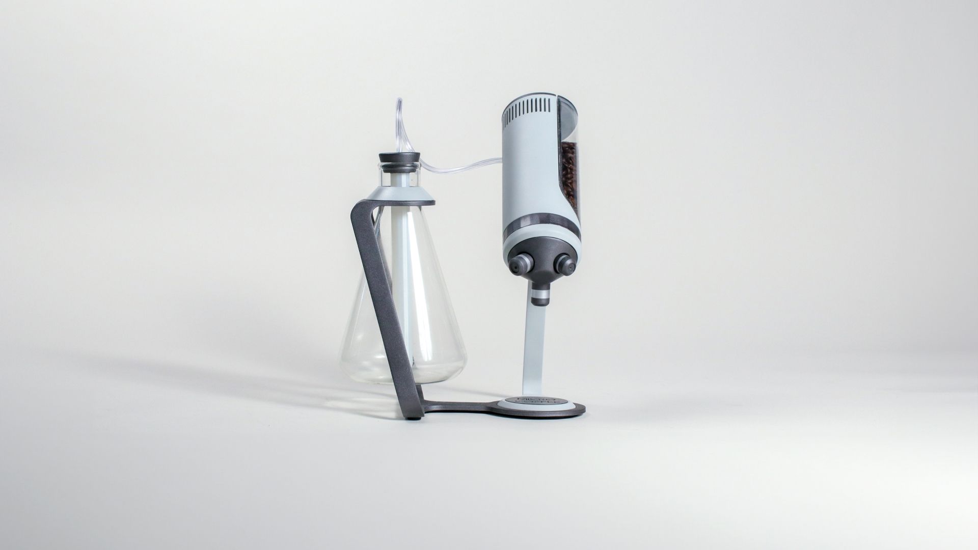 Side view of the Microcoffee brewer at rest, the flask and bean cylinder upright.