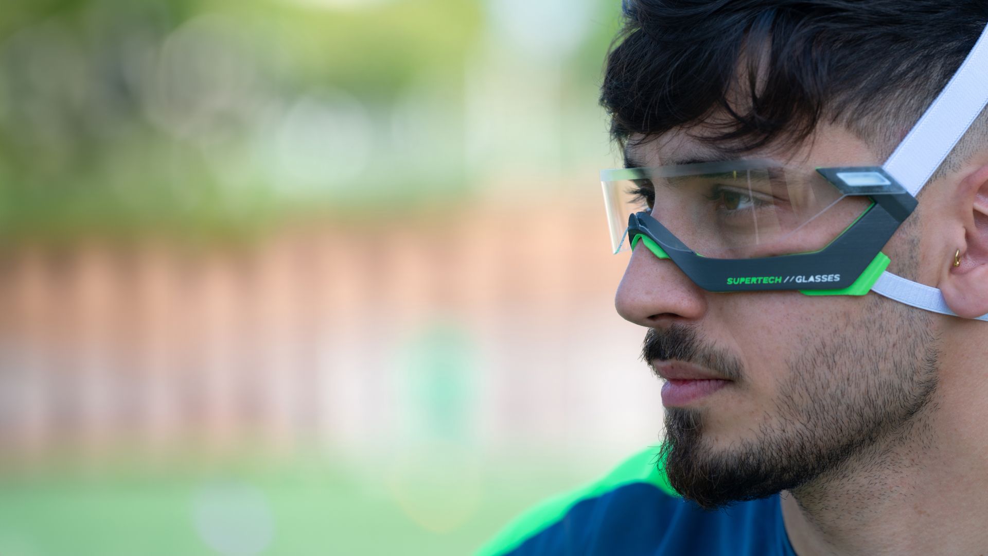 Side profile of an athlete wearing the Rayzor glasses outdoors.
