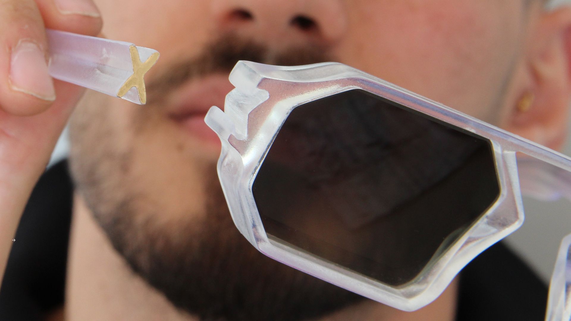 Macro close-up of a translucent Unfoldable frame showing the snap-on X-connector.