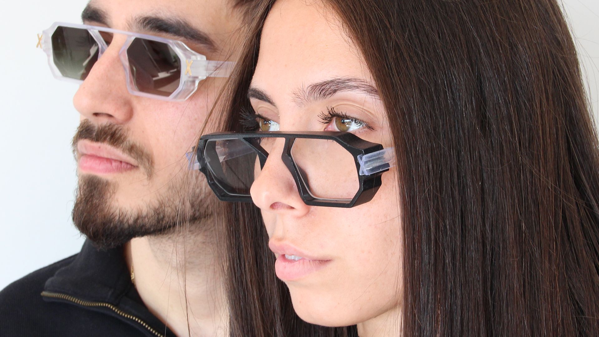 A man and woman side by side wearing Unfoldable eyewear — sunglasses and clear frames.